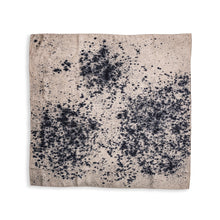 A square scarf with a beige background and a black ink-blot style abstract pattern, displayed flat against a white background.