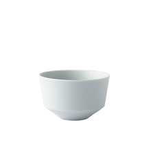 A minimalist ceramic bowl with a wide rim and a tapered, geometric flared base, shown in a solid pale blue-gray color on a pure white background.