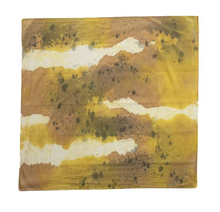 An abstract square art print or textile featuring a textured landscape-like pattern in shades of ochre yellow, brown, beige, and white, isolated on a white background.